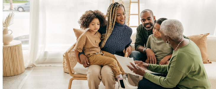young couple with two children speaking with an estate planning attorney