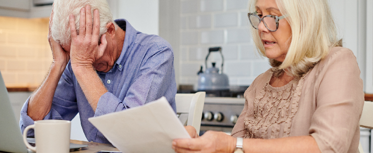 elderly couple looking stresses while doing their estate planning